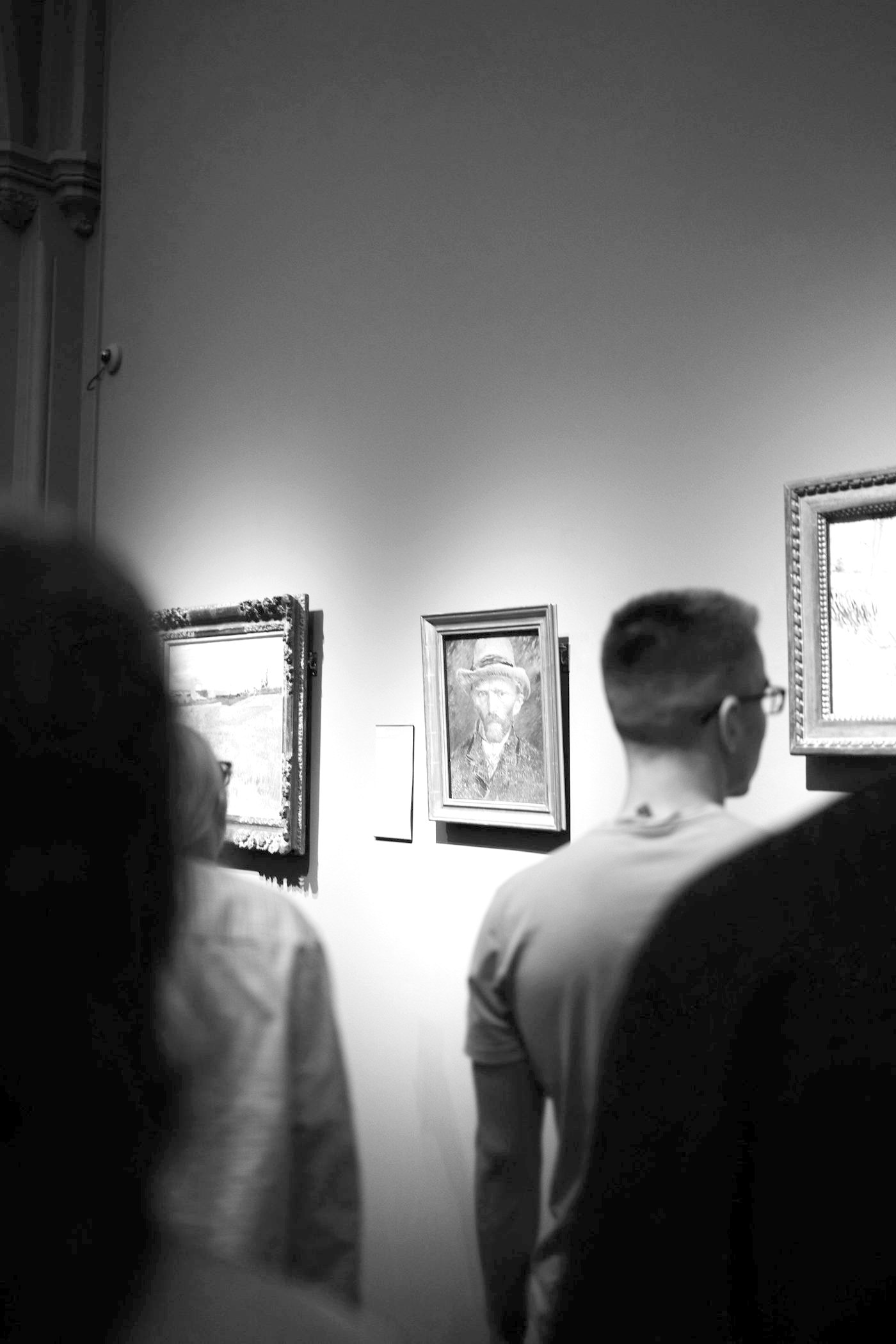 People looking at paintings in a gallery